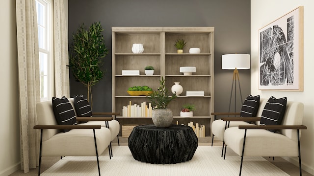 living area featuring baseboards, carpet floors, and plenty of natural light