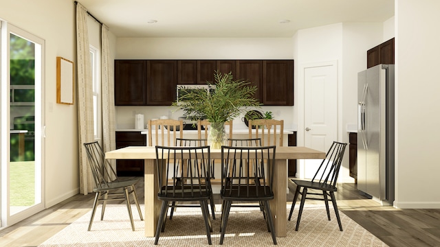 dining room with light wood-type flooring and baseboards