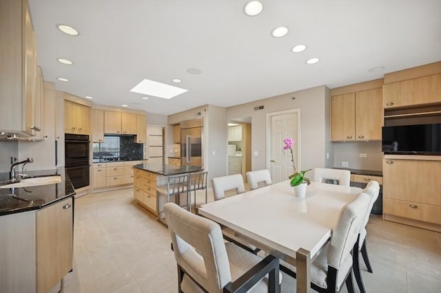 1700 2nd St Unit 509, Highland Park, IL 60035 - dining area featuring washer and clothes dryer, light tile patterned flooring, recessed lighting, and a skylight