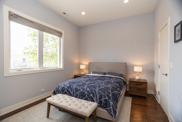bedroom with baseboards, recessed lighting, and wood finished floors