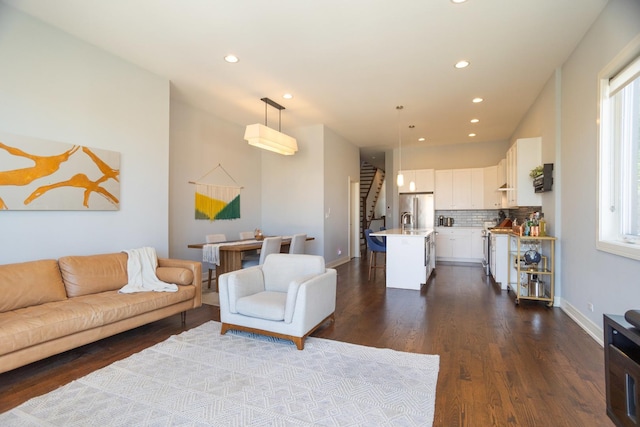 living room featuring recessed lighting, stairway, dark wood finished floors, and baseboards