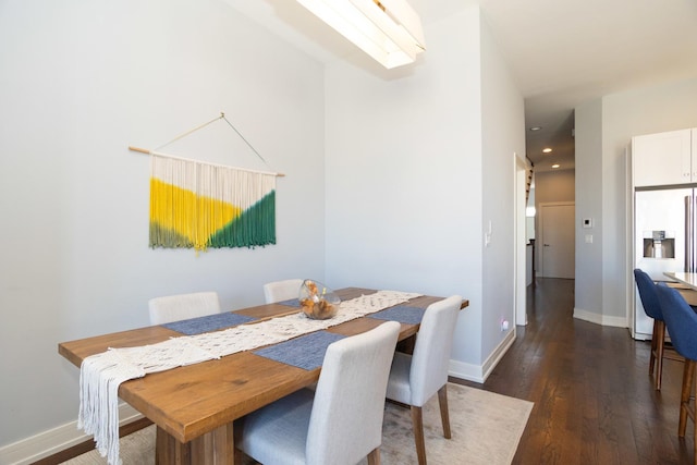 dining room with dark wood-style flooring, baseboards, and recessed lighting
