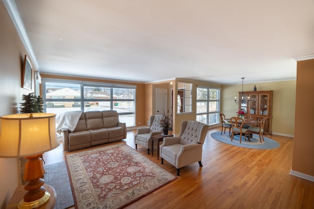 1841 Hawthorne Ave, Westchester, IL 60154 - living room featuring crown molding, healthy amount of natural light, light wood-type flooring, and a chandelier