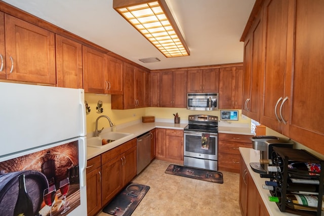 1841 Hawthorne Ave, Westchester, IL 60154 - kitchen featuring appliances with stainless steel finishes, brown cabinetry, and light countertops