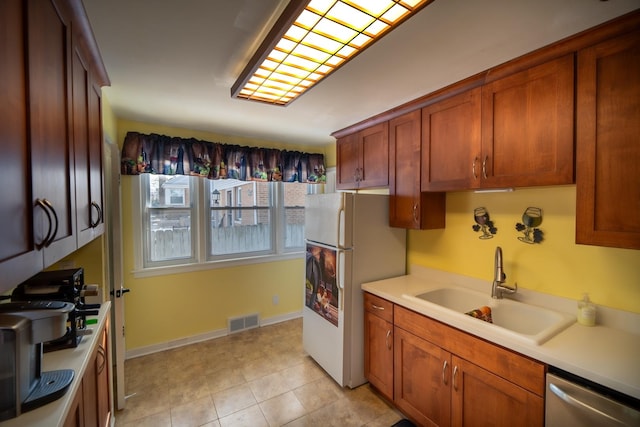 1841 Hawthorne Ave, Westchester, IL 60154 - kitchen featuring stainless steel dishwasher, freestanding refrigerator, light countertops, and brown cabinetry