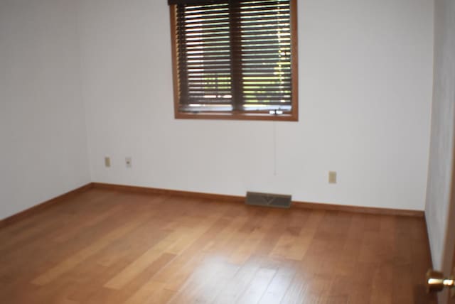 1925 W Mesa Dr Unit 1, Freeport, IL 61032 - empty room featuring wood finished floors and baseboards