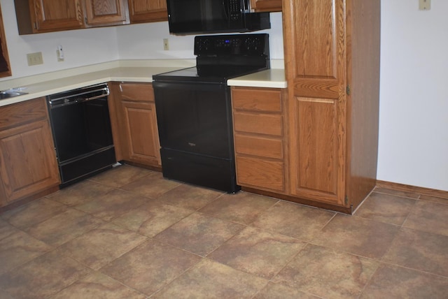 1925 W Mesa Dr Unit 1, Freeport, IL 61032 - kitchen with black appliances, light countertops, brown cabinets, and baseboards