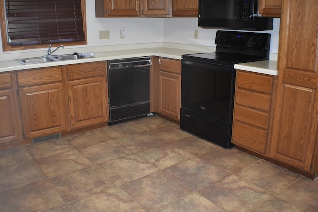 1925 W Mesa Dr Unit 1, Freeport, IL 61032 - kitchen featuring black appliances, a sink, brown cabinetry, and light countertops
