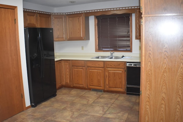 1925 W Mesa Dr Unit 1, Freeport, IL 61032 - kitchen with black appliances, a sink, brown cabinetry, and light countertops