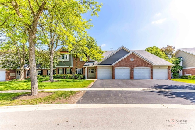 2442 Charleston Dr Unit 5, Schaumburg, IL 60193 - view of front of house with brick siding, a front yard, asphalt driveway, and an attached garage