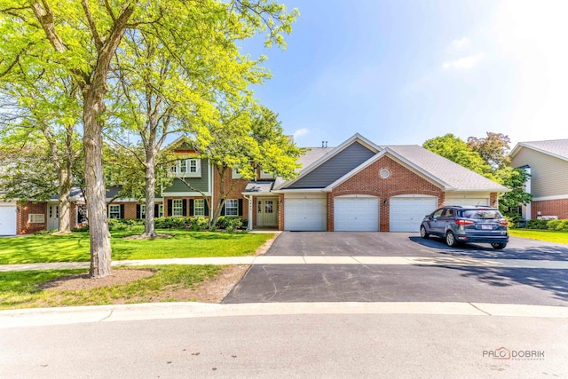 2442 Charleston Dr Unit 5, Schaumburg, IL 60193 - view of front facade featuring a front yard, brick siding, a garage, and asphalt driveway