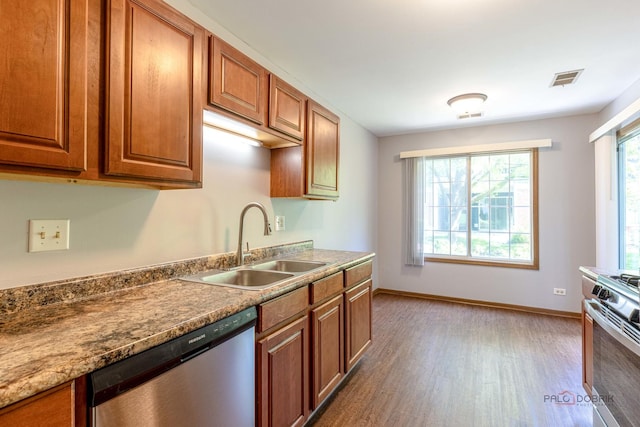 2442 Charleston Dr Unit 5, Schaumburg, IL 60193 - kitchen with stainless steel appliances, a sink, wood finished floors, baseboards, and brown cabinetry