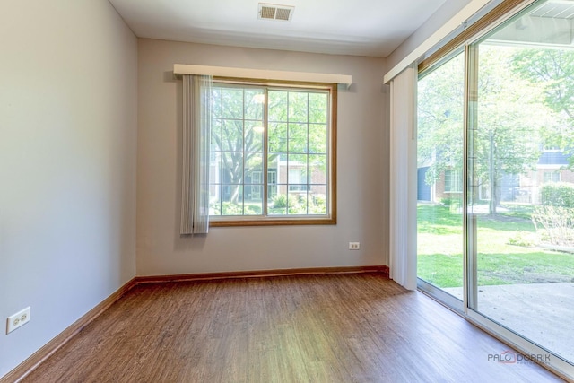 2442 Charleston Dr Unit 5, Schaumburg, IL 60193 - unfurnished room with wood finished floors, healthy amount of natural light, and baseboards
