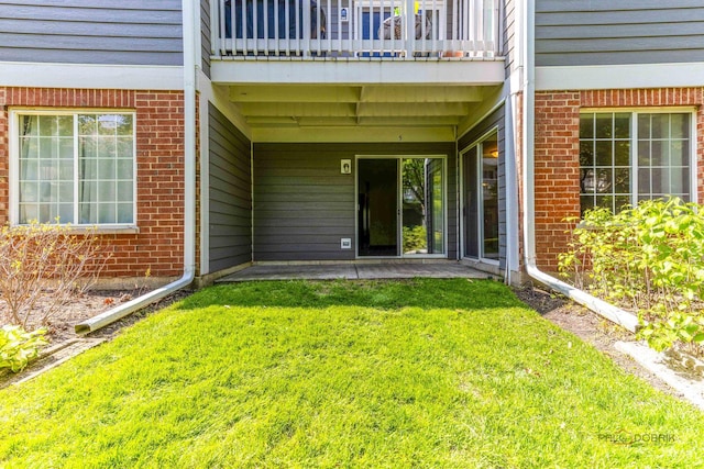 2442 Charleston Dr Unit 5, Schaumburg, IL 60193 - entrance to property featuring brick siding, a yard, a balcony, and a patio