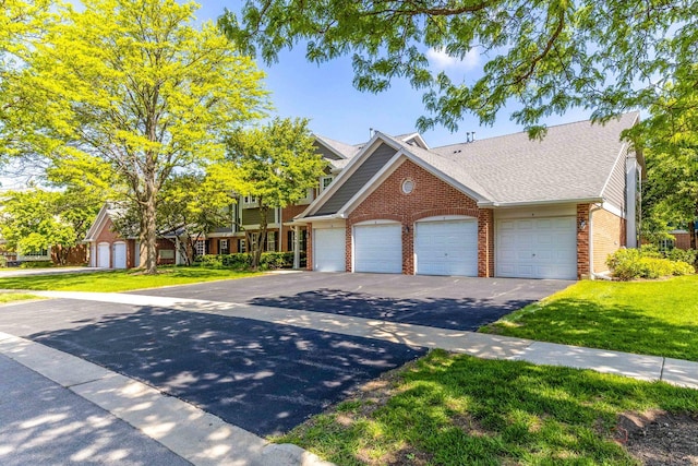 2442 Charleston Dr Unit 5, Schaumburg, IL 60193 - view of front of house featuring brick siding, asphalt driveway, a front yard, and a shingled roof