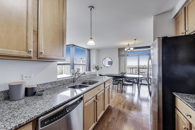 1160 S Michigan Ave Unit 1503, Chicago, IL 60605 - kitchen featuring stainless steel appliances, a sink, dark wood-style floors, light stone counters, and decorative light fixtures
