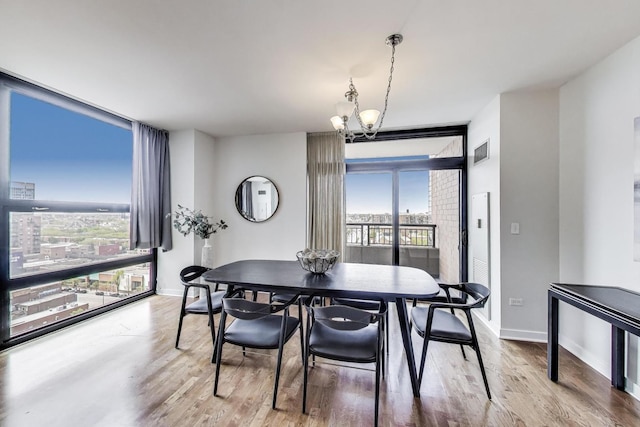 1160 S Michigan Ave Unit 1503, Chicago, IL 60605 - dining space featuring expansive windows, wood finished floors, baseboards, and a chandelier