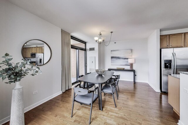 1160 S Michigan Ave Unit 1503, Chicago, IL 60605 - dining space with a chandelier, wood finished floors, and baseboards