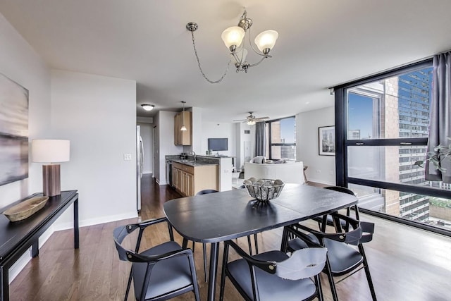 1160 S Michigan Ave Unit 1503, Chicago, IL 60605 - dining room featuring a wall of windows, a chandelier, ceiling fan, dark wood-style flooring, and baseboards