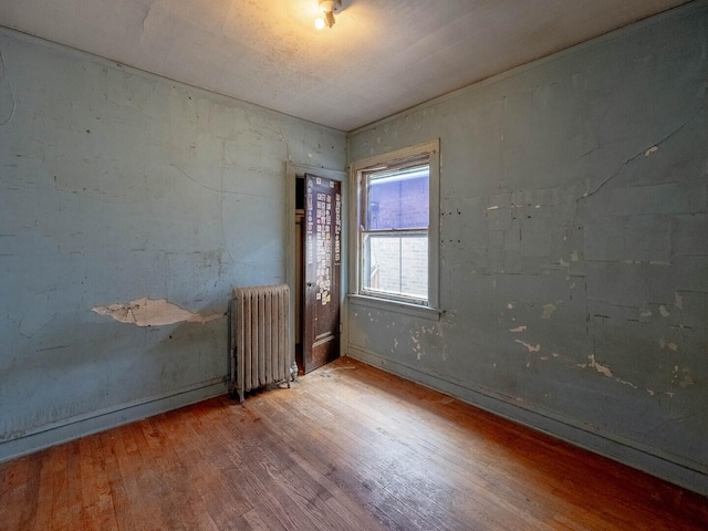 1745 E 85th St, Chicago, IL 60617 - empty room featuring radiator and wood finished floors
