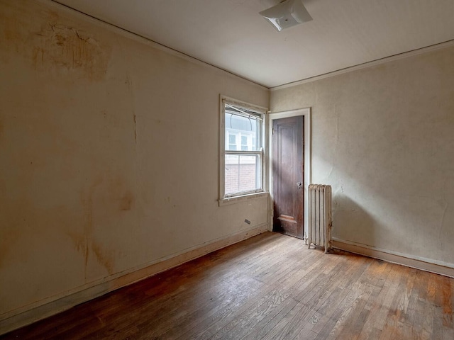 1745 E 85th St, Chicago, IL 60617 - empty room with radiator, hardwood / wood-style flooring, and baseboards