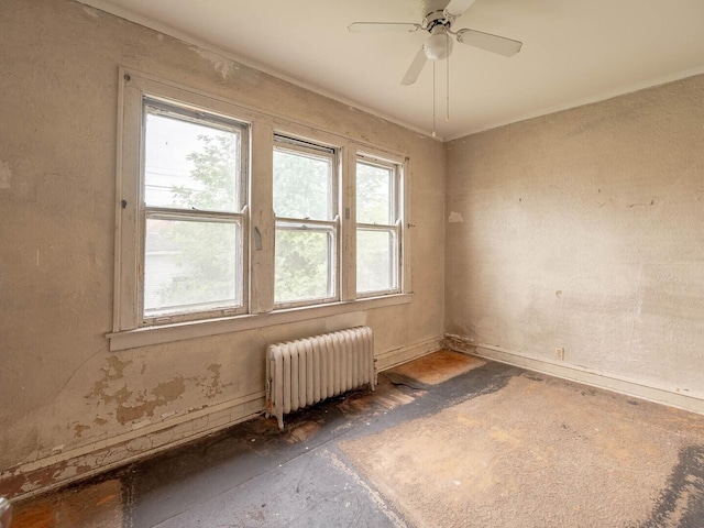 1745 E 85th St, Chicago, IL 60617 - spare room featuring radiator heating unit, a ceiling fan, and baseboards
