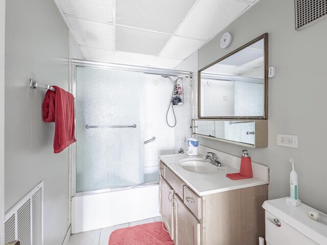 850 Des Plaines Ave Unit 207, Forest Park, IL 60130 - bathroom with bath / shower combo with glass door, vanity, tile patterned flooring, toilet, and a paneled ceiling