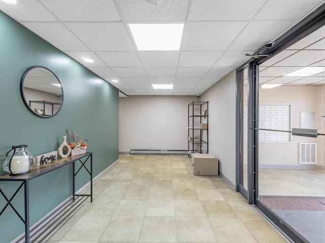 850 Des Plaines Ave Unit 207, Forest Park, IL 60130 - hall featuring a paneled ceiling, a baseboard heating unit, and baseboards