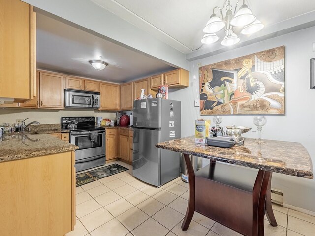 850 Des Plaines Ave Unit 207, Forest Park, IL 60130 - kitchen featuring stainless steel appliances, a chandelier, stone countertops, light tile patterned flooring, and hanging light fixtures