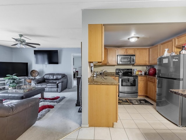 850 Des Plaines Ave Unit 207, Forest Park, IL 60130 - kitchen featuring stainless steel appliances, open floor plan, a ceiling fan, light stone counters, and light tile patterned floors