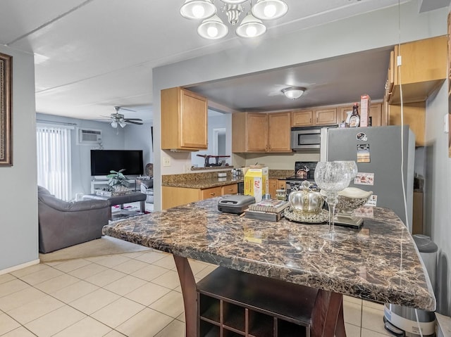 850 Des Plaines Ave Unit 207, Forest Park, IL 60130 - kitchen featuring light tile patterned floors, open floor plan, ceiling fan, a breakfast bar, and stainless steel appliances