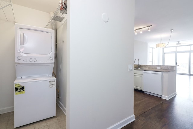 1600 S Prairie Ave Unit 810, Chicago, IL 60616 - laundry room with estacked washer and dryer, baseboards, and wood finished floors