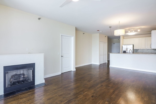 1600 S Prairie Ave Unit 810, Chicago, IL 60616 - unfurnished living room featuring dark wood-type flooring, a fireplace, baseboards, and a sink