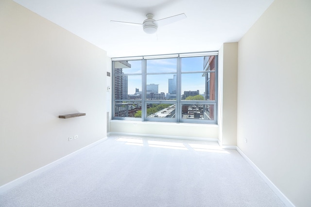 1600 S Prairie Ave Unit 810, Chicago, IL 60616 - carpeted empty room featuring ceiling fan, a skyline view, and baseboards
