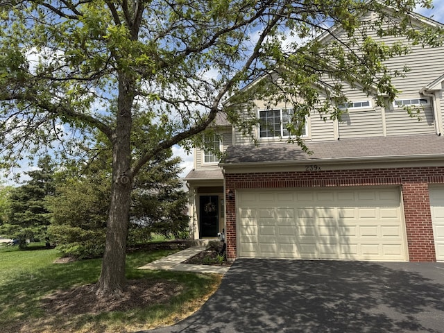 239 Nicole Dr Unit A, South Elgin, IL 60177 - traditional-style house with brick siding, asphalt driveway, and an attached garage