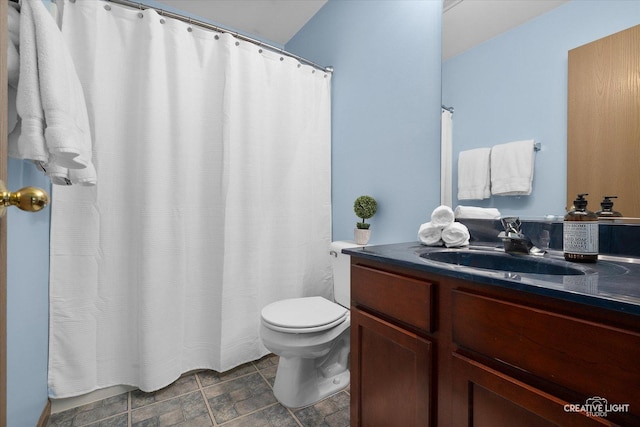 239 Nicole Dr Unit A, South Elgin, IL 60177 - bathroom featuring vanity, toilet, stone finish flooring, and curtained shower