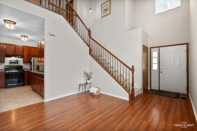 239 Nicole Dr Unit A, South Elgin, IL 60177 - entrance foyer with a towering ceiling, stairway, light wood-style floors, and baseboards