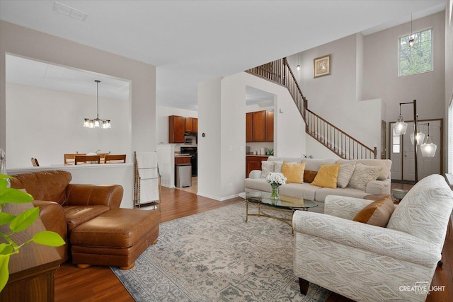 239 Nicole Dr Unit A, South Elgin, IL 60177 - living area featuring wood finished floors, a chandelier, and stairs