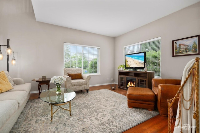 239 Nicole Dr Unit A, South Elgin, IL 60177 - living area with wood finished floors, baseboards, and a lit fireplace
