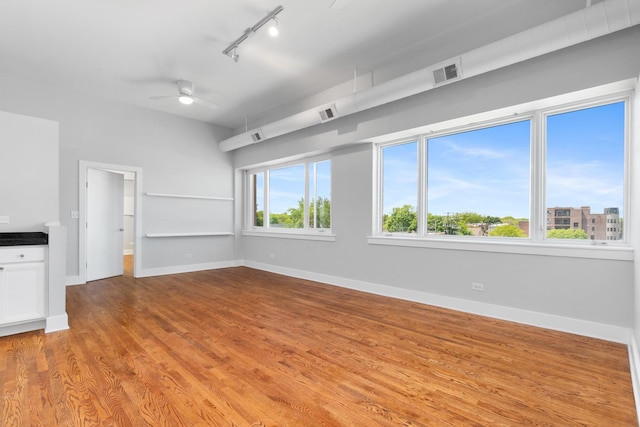 4751 N Artesian Ave Unit 401, Chicago, IL 60625 - spare room featuring track lighting, wood finished floors, a ceiling fan, and baseboards