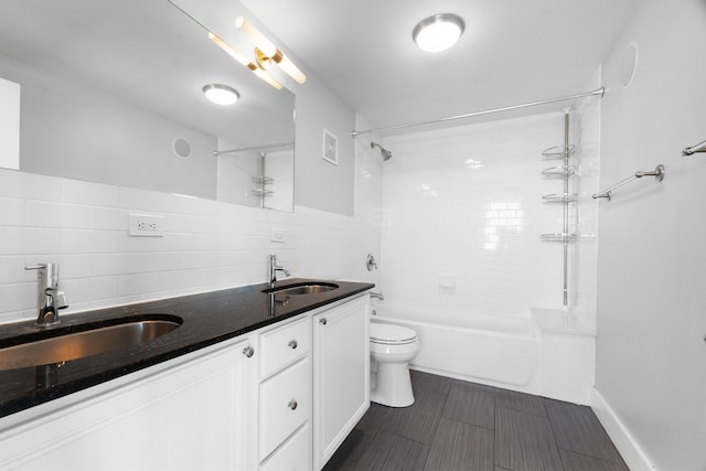 4751 N Artesian Ave Unit 401, Chicago, IL 60625 - full bath featuring toilet, shower / washtub combination, double vanity, tile walls, and decorative backsplash