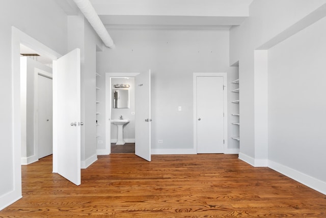 4751 N Artesian Ave Unit 401, Chicago, IL 60625 - unfurnished bedroom with baseboards, wood finished floors, and ensuite bath