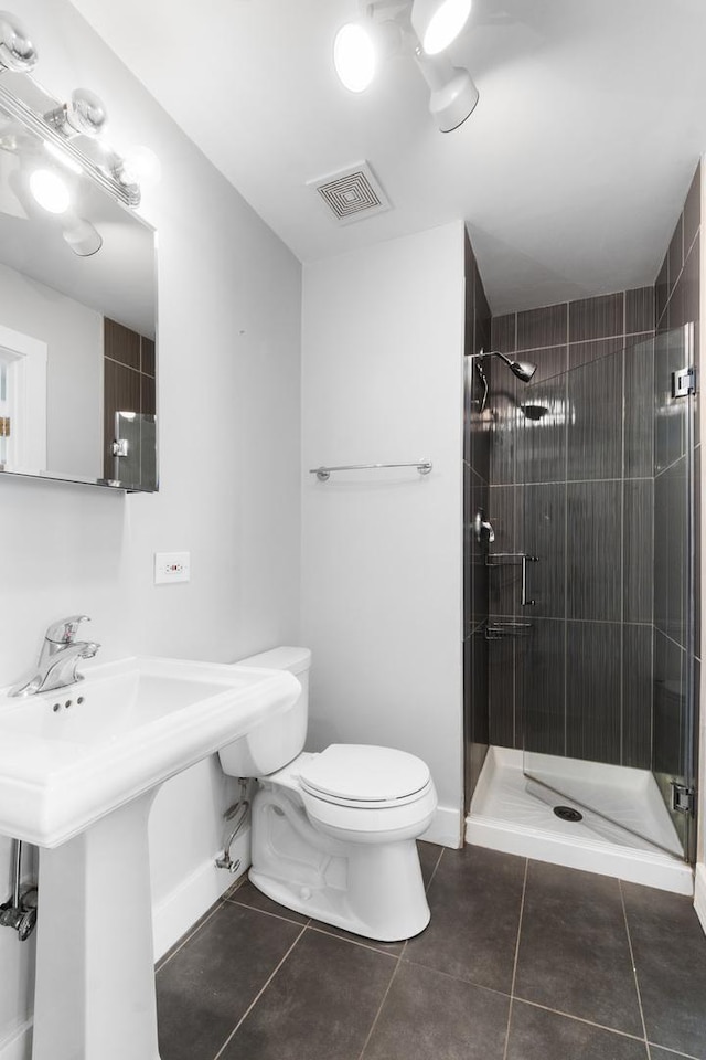 4751 N Artesian Ave Unit 401, Chicago, IL 60625 - full bathroom featuring toilet, tile patterned floors, a stall shower, a sink, and baseboards