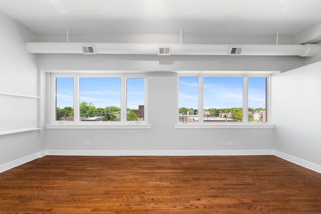 4751 N Artesian Ave Unit 401, Chicago, IL 60625 - unfurnished room with healthy amount of natural light, wood finished floors, and baseboards