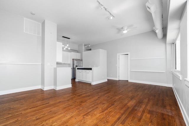 4751 N Artesian Ave Unit 401, Chicago, IL 60625 - unfurnished living room with track lighting, dark wood-style floors, ceiling fan, and baseboards