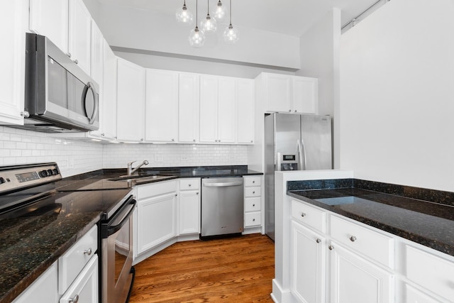 4751 N Artesian Ave Unit 401, Chicago, IL 60625 - kitchen featuring appliances with stainless steel finishes, a sink, backsplash, and white cabinetry