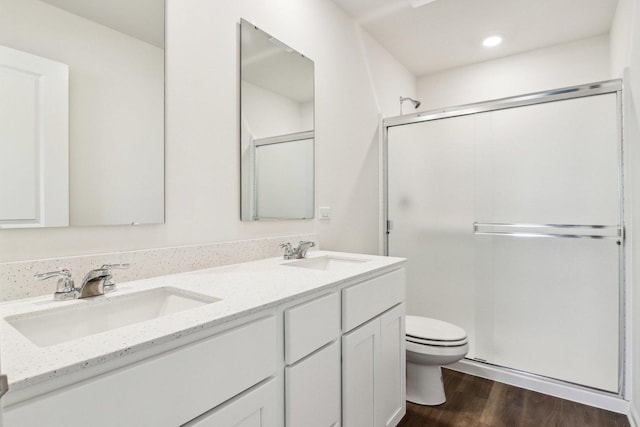 6335 Ulster Dr, Tinley Park, IL 60477 - bathroom featuring toilet, a stall shower, wood finished floors, double vanity, and recessed lighting