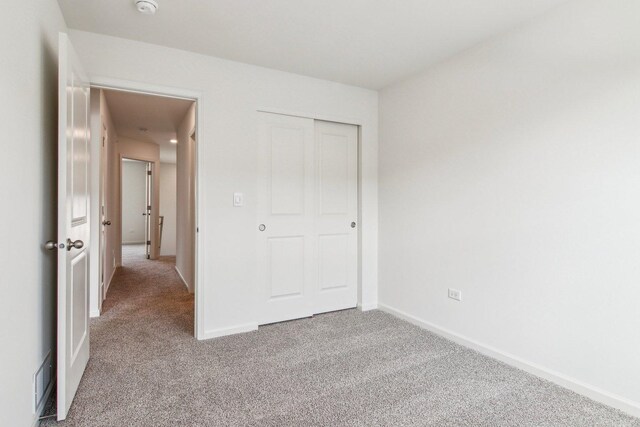 6335 Ulster Dr, Tinley Park, IL 60477 - unfurnished bedroom featuring carpet floors, baseboards, and a closet