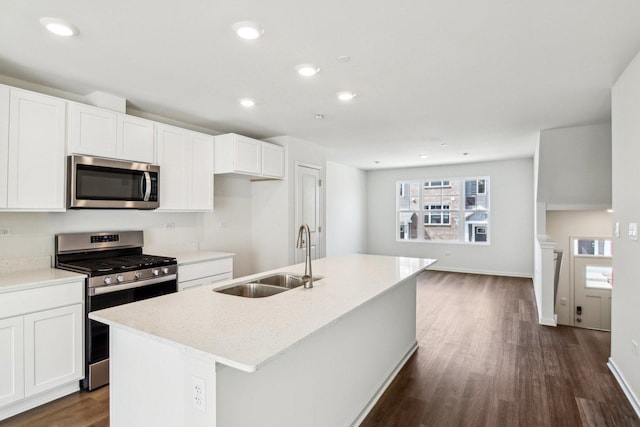 6335 Ulster Dr, Tinley Park, IL 60477 - kitchen featuring appliances with stainless steel finishes, a sink, dark wood-style flooring, a kitchen island with sink, and white cabinets