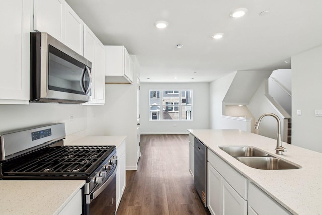 6335 Ulster Dr, Tinley Park, IL 60477 - kitchen with stainless steel appliances, a sink, dark wood finished floors, white cabinets, and light stone counters